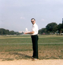 David Burns holding the U.S. Capitol Building in the palms of his hands