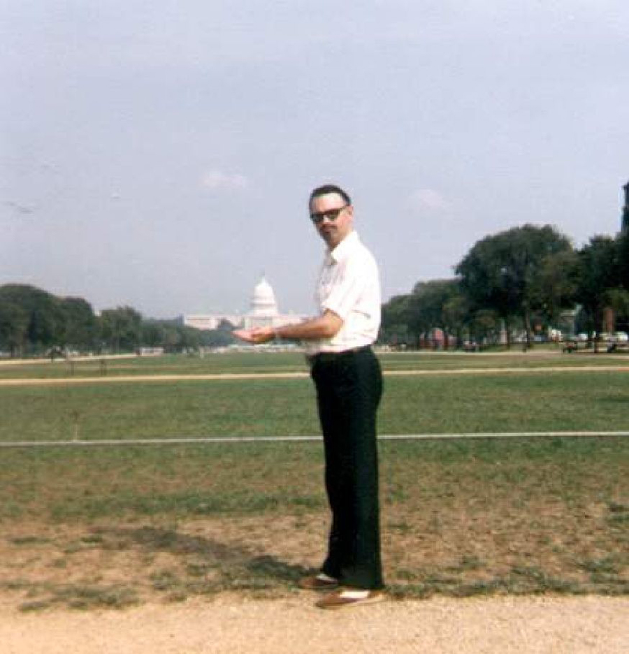 David Burns holding the U.S. Capitol Building in the palms of his hands